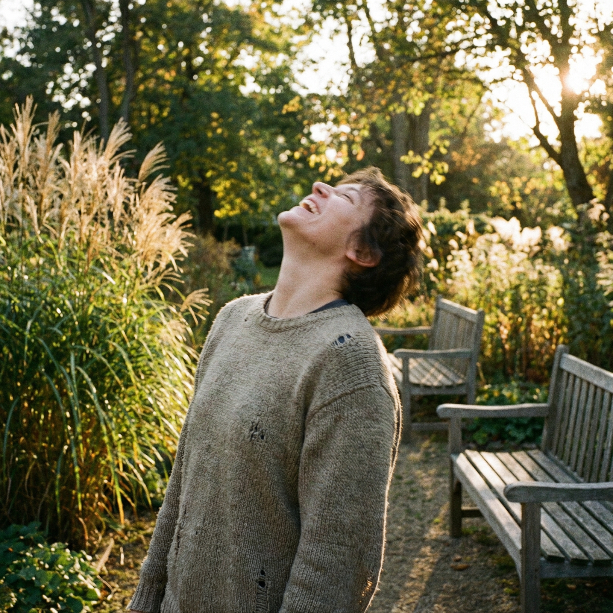 A candid, slightly blurry photograph of a person laughing heartily in a natural, unposed setting. Lifestyle photography, warm lighting, natural setting. 1:1 aspect ratio, no visible text.