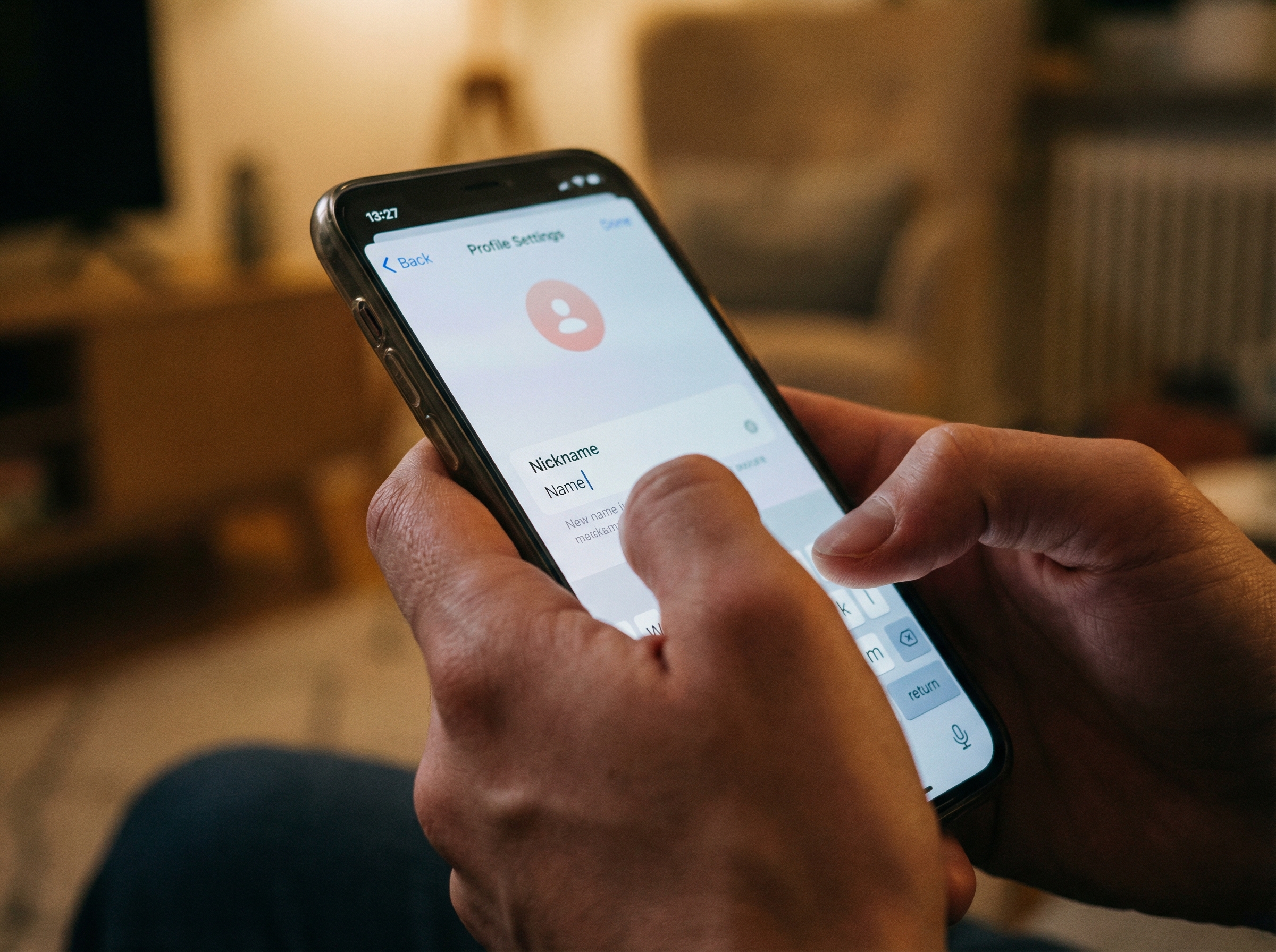 A realistic close up shot of a person using a smartphone to edit their profile nickname in a messaging app interface warm indoor lighting natural hands 4:3 no text