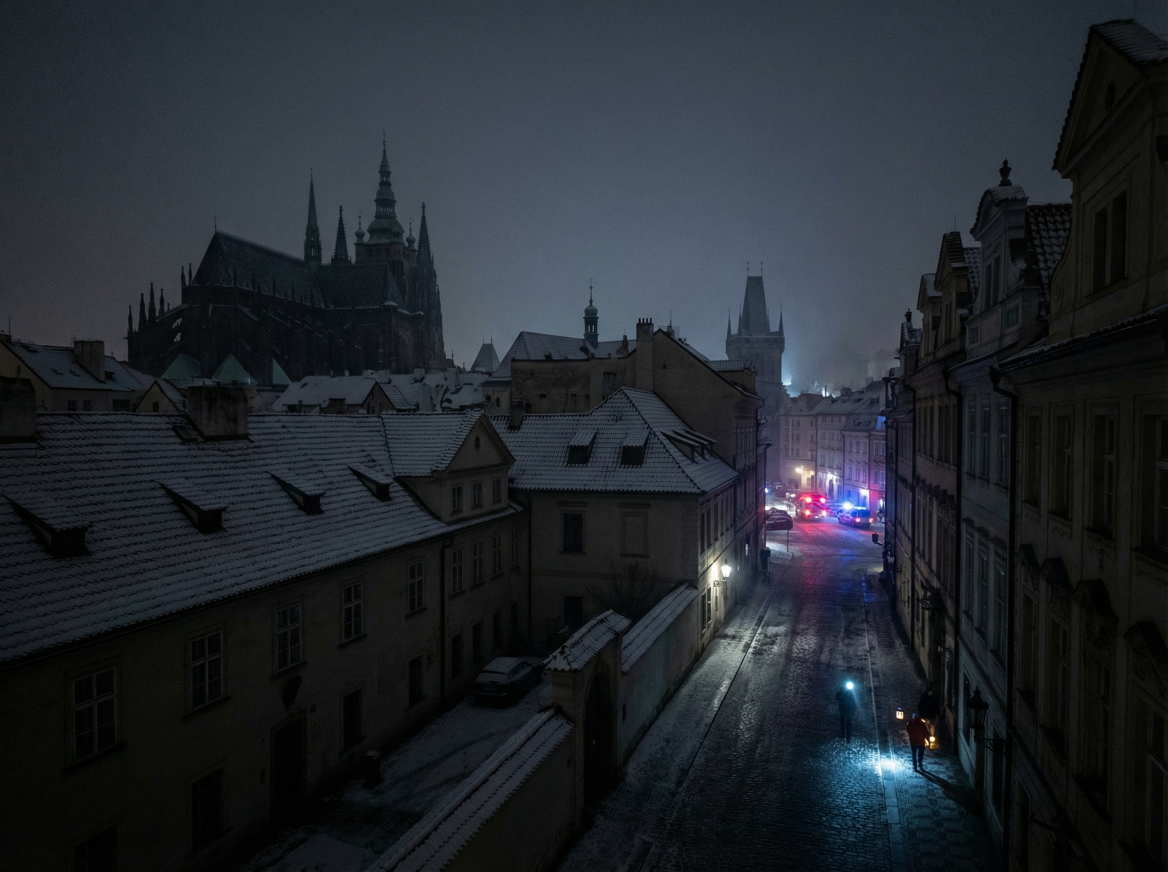 A cinematic, realistic wide-angle photo of a European city district at night with almost all lights out, only a few flashlights and emergency vehicle sirens visible, dark silhouettes of buildings against a cold winter sky, 4:3, no text